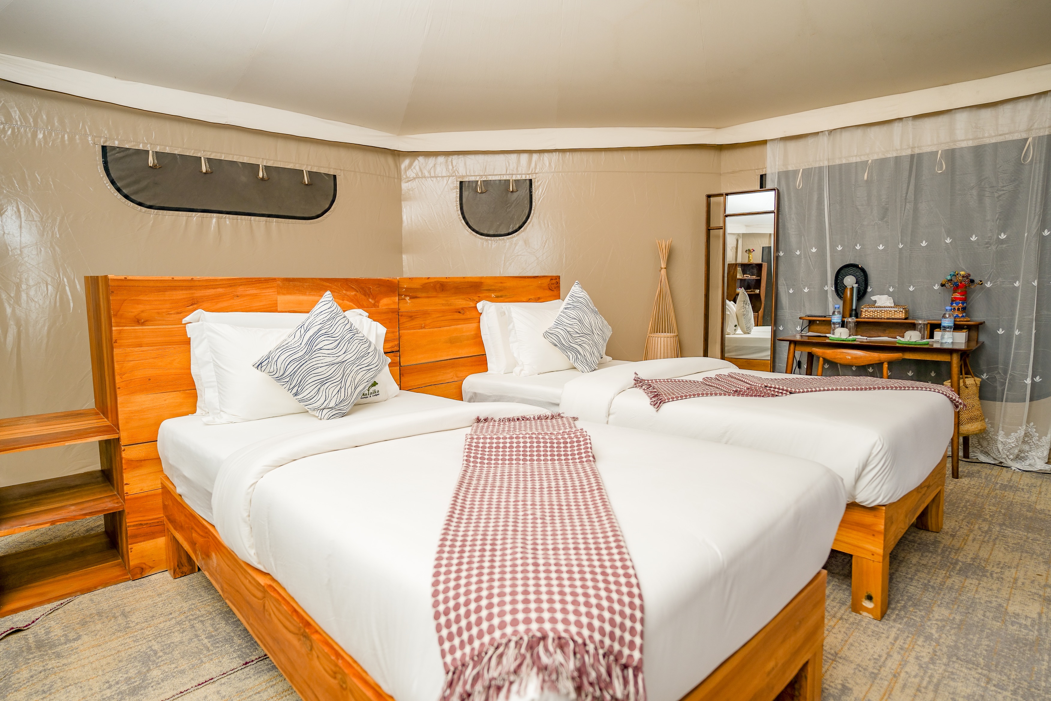 Luxury family tent interior with modern seating and bathtub overlooking savanna