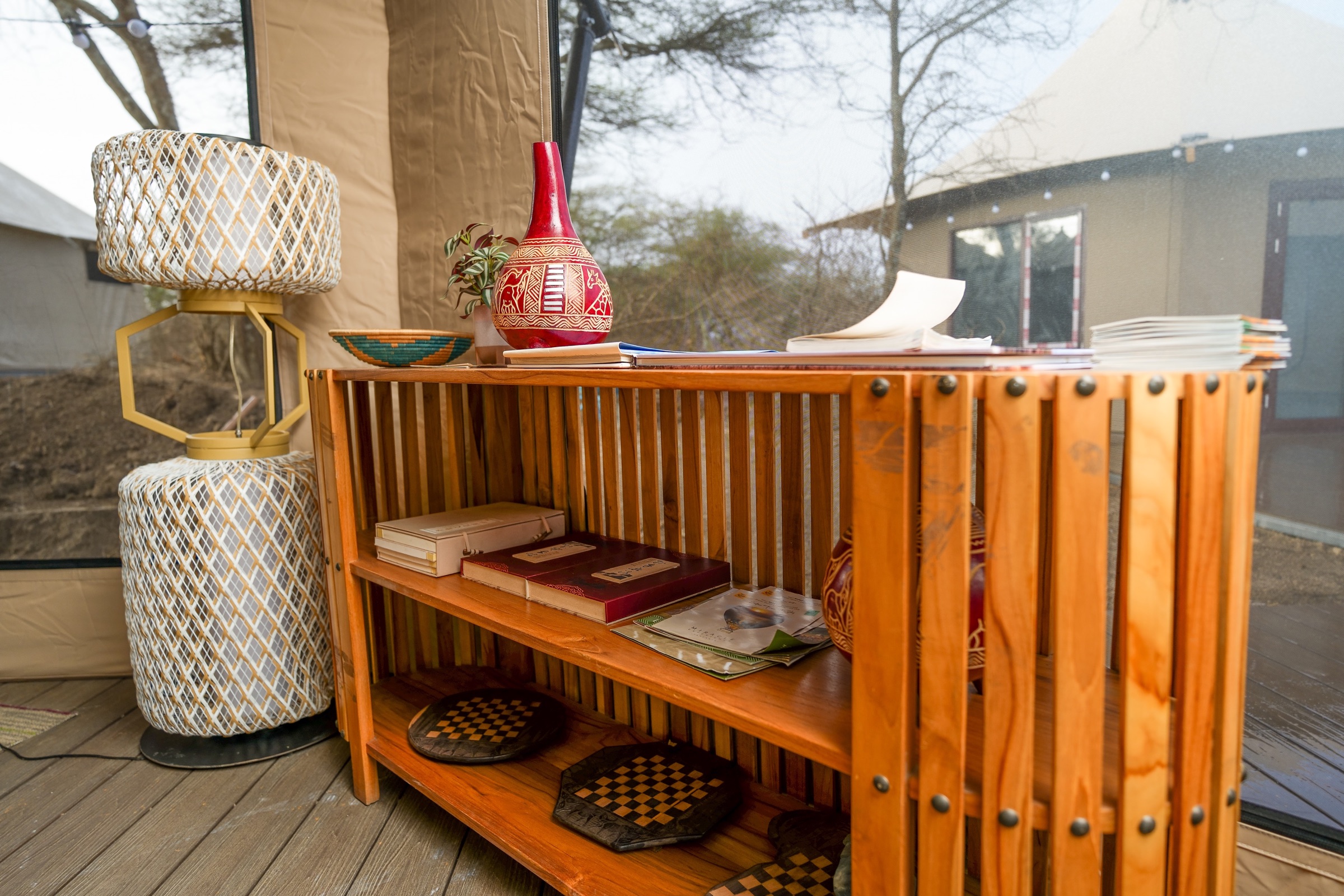 Main camp lounge with wooden floors and African-inspired decor