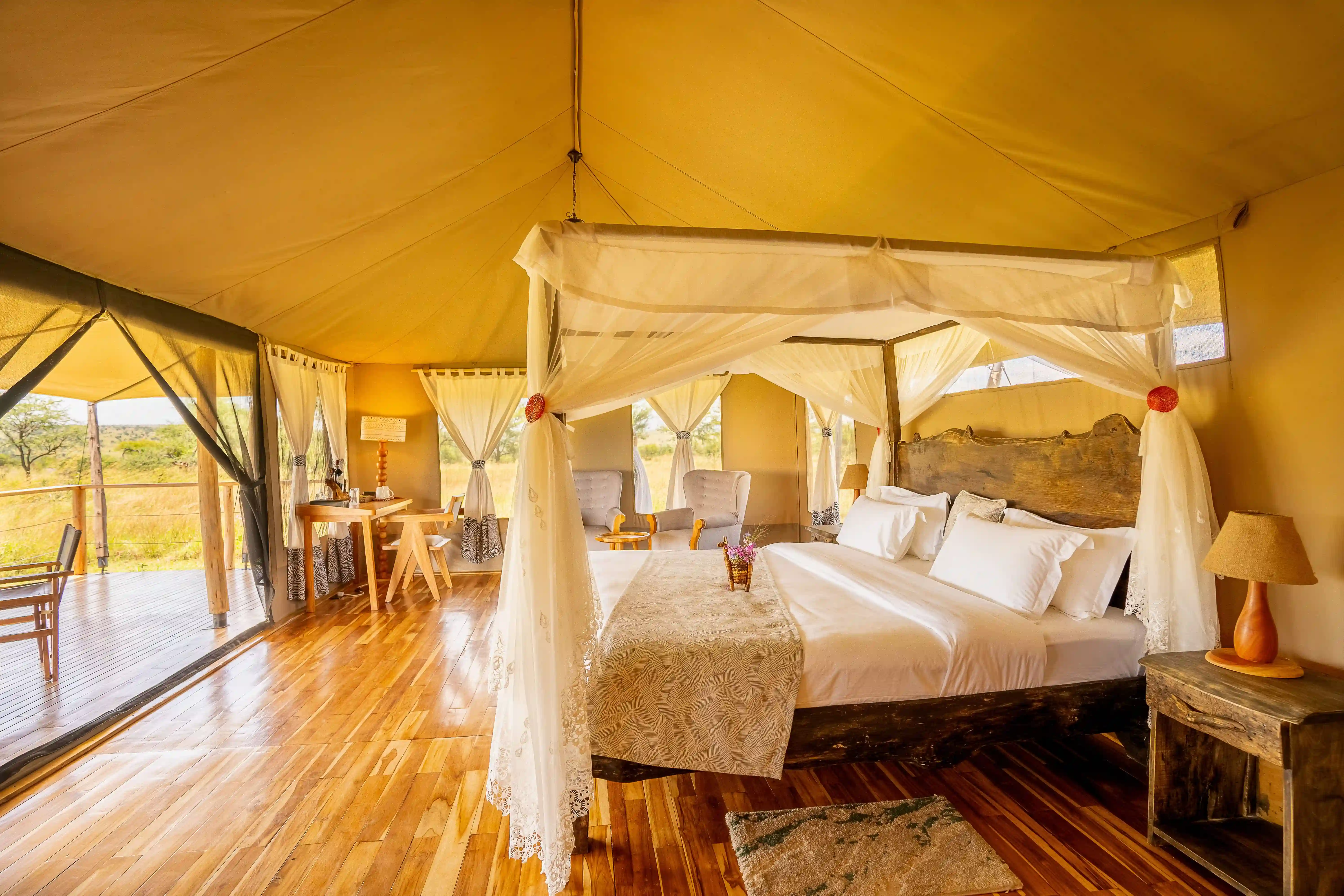 Luxury tent interior with seating area and wooden floors